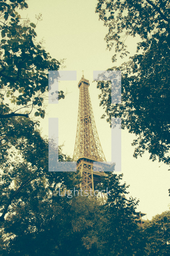 view of the Eiffel tower above the trees 