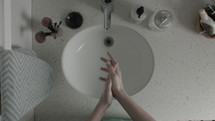 washing hands in a sink 