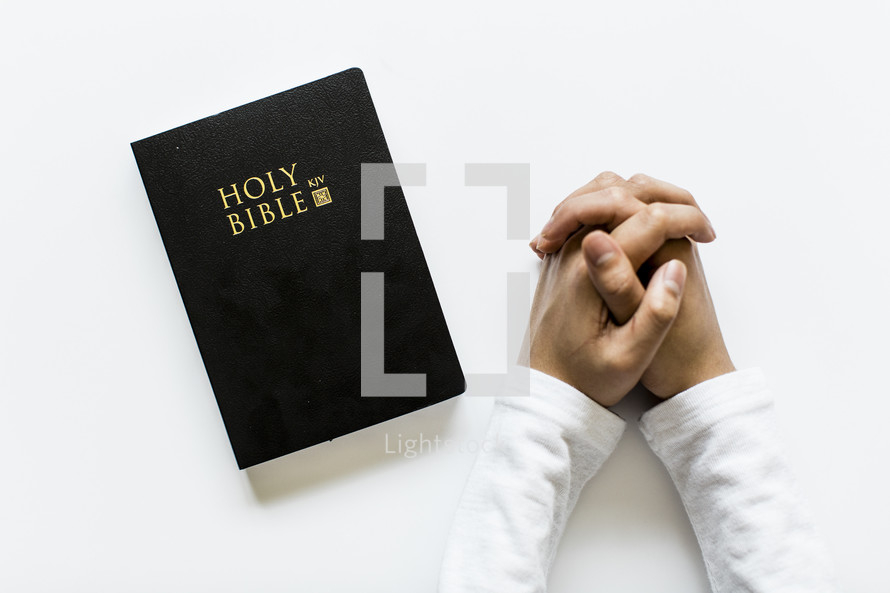 praying hands and Bible 