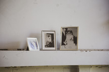 framed photographs on a mantel 