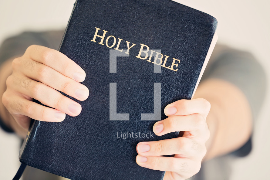 Young Man Holding The Holy Bible