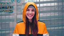 a smiling woman in a hoodie 