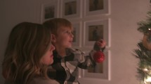 mother and son decorating a Christmas tree 