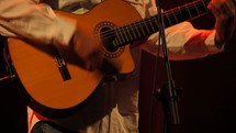 Guitarist playing his spanish classic guitar at live music concert