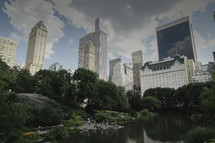 lake in central park surrounded by skyscrapers 