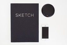 sketch pad, coffee cup, and iPhone 