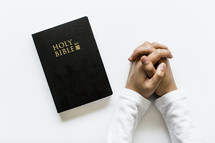 praying hands and Bible 