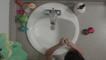washing hands in a sink 