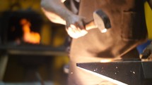 Blacksmith Forging a Sword  with Hammer in a Workshop Slow Motion