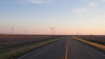 Driving POV of wind turbines along a country road