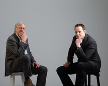 businessmen sitting next to each other in studio 