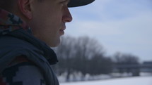 a man looking into the distance in winter 