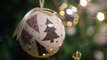 White ball decoration on the branches of a Christmas tree 