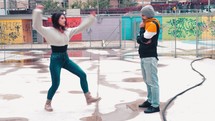 a man and woman dancing in a park 