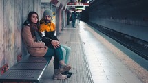 a couple waiting in a subway 