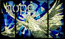 A stained glass art painting of the Holy Spirit descending as a dove with the words 'hope' representing the hope that is Christ to a lost world. A beautiful blue and white stained glass window with multiple polygons, tiles or cut glass depicting the Holy Spirit as a Dove. 