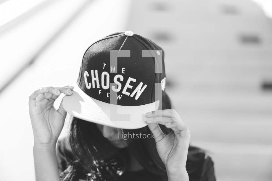 woman wearing a ball cap with the words the chosen few 