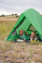 children in a tent outdoors 