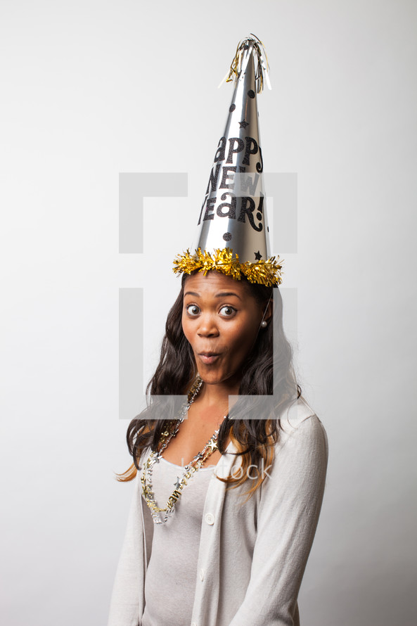 A woman wearing a Happy new Years party hat. 