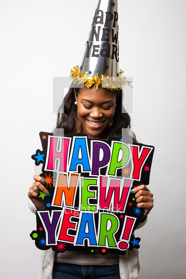 A woman holding a Happy New Year sign