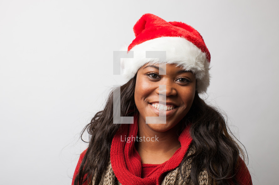 A woman wearing a Santa hat 