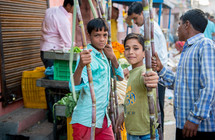 children with bamboo sticks at a market in Mandawa, India 