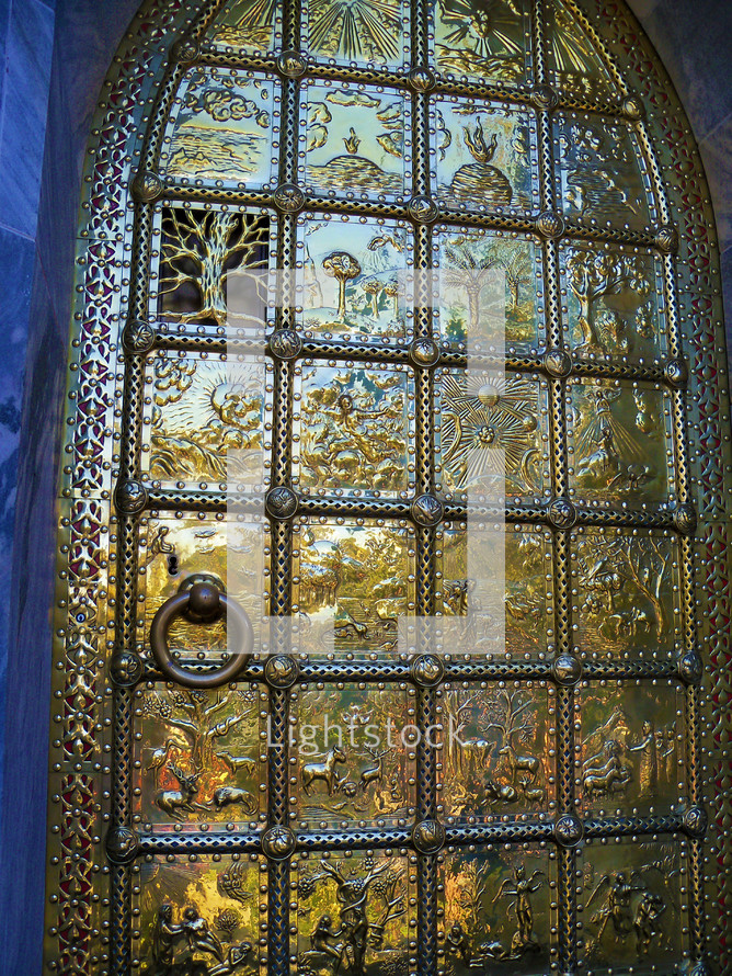 The story of creation from the book of Genesis on a large brass door entrance using panels and engravings to tell the story of Creation from the book of Genesis. 