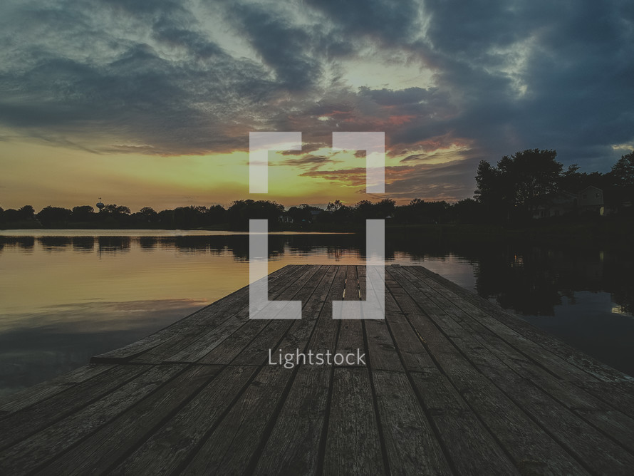 dock over a lake at sunset 
