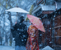 women holding umbrellas in the snow