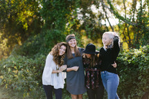 portrait of female friends standing together outdoors 