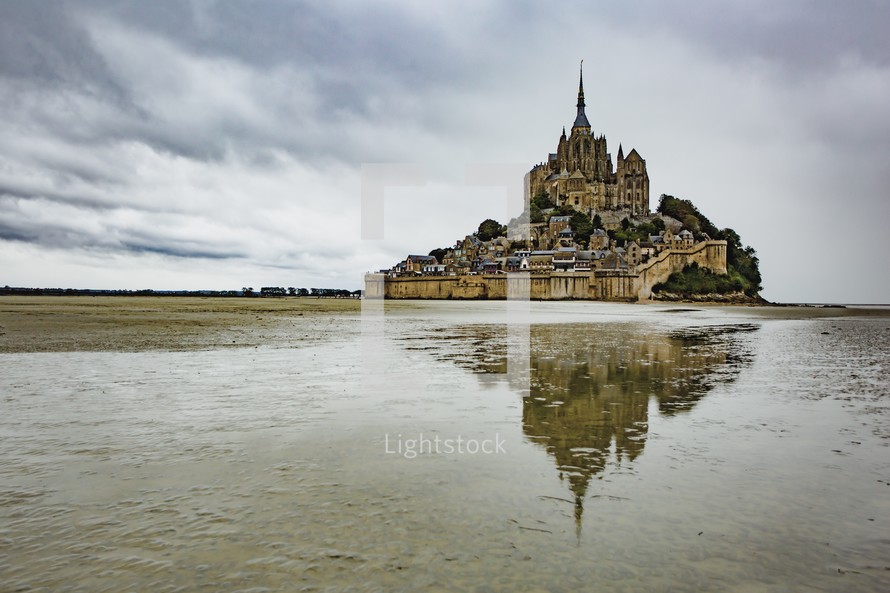 Moody reflection of Mont Saint Michel cathedral in France