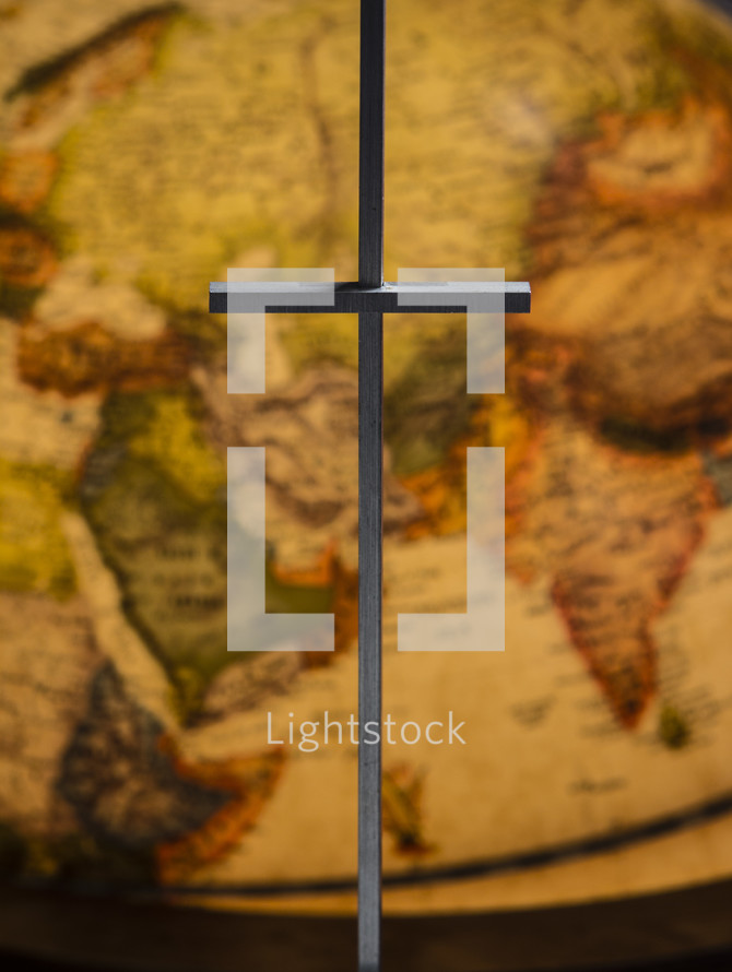 cross in front of a globe 