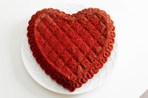 A red heart shaped cake.