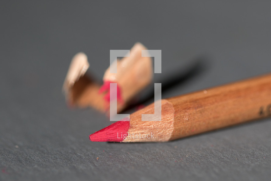 red colored pencil and pencil shavings 