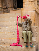 a man wrapping a turban in India 