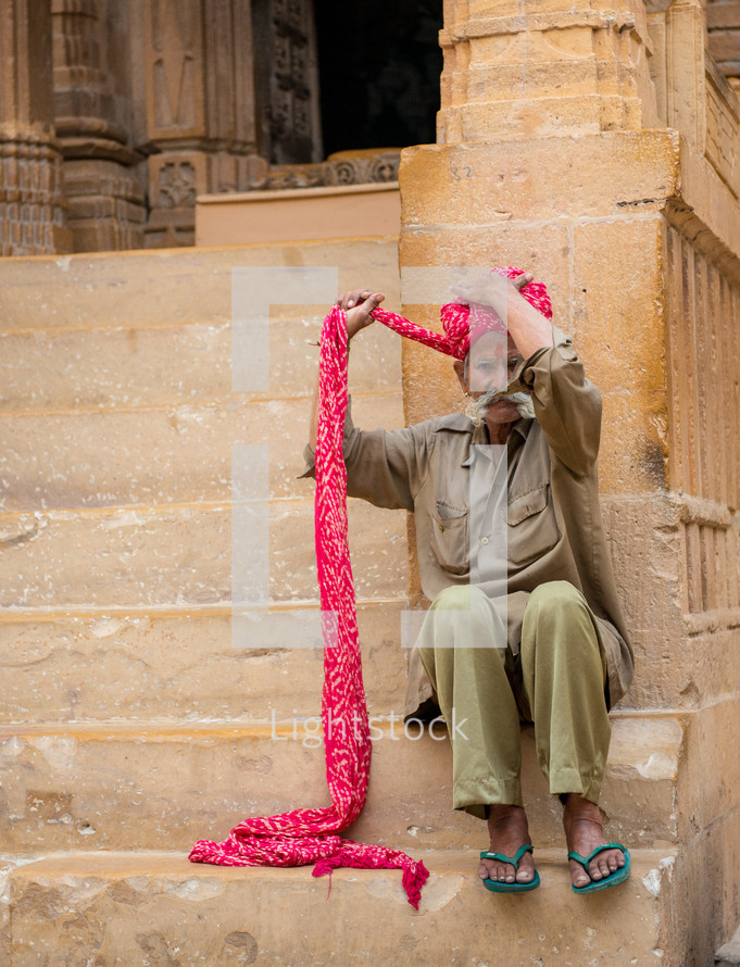a man wrapping a turban in India 
