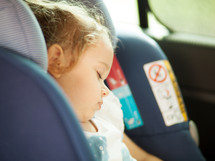 child napping in a carseat 