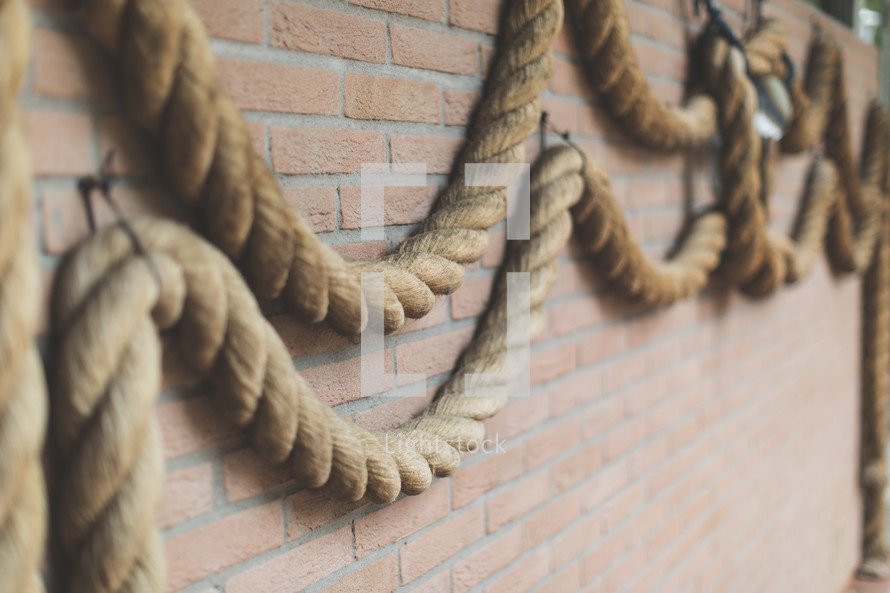 Heavy rope on a brick wall.