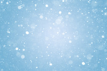 Falling snow icy winter bokeh lights and snowflakes abstract backdrop. Snowing frozen blizzard background texture.