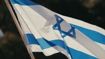 Israeli flag on a pole waving in slow motion
