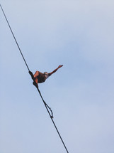 man balancing on a rope 