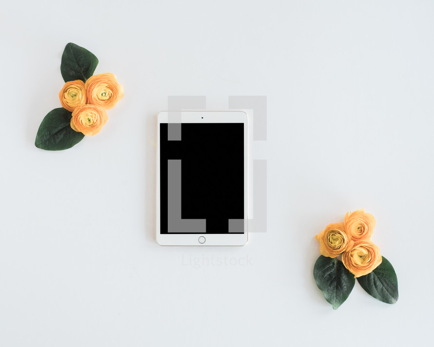 yellow roses and tablet 