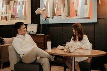 a couple having coffee together at a coffee shop 