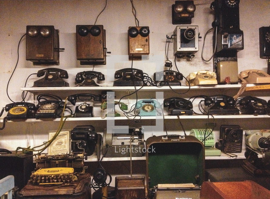 shelves of antique phones and typewriters 