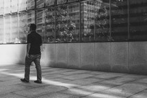 man walking past One World Trade Center