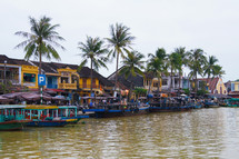 Boats line the river in town on a busy market day