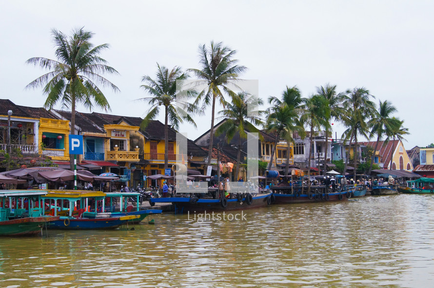 Boats line the river in town on a busy market day