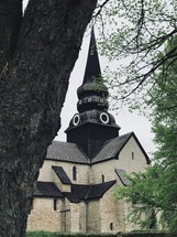 black steeple on a stone church 