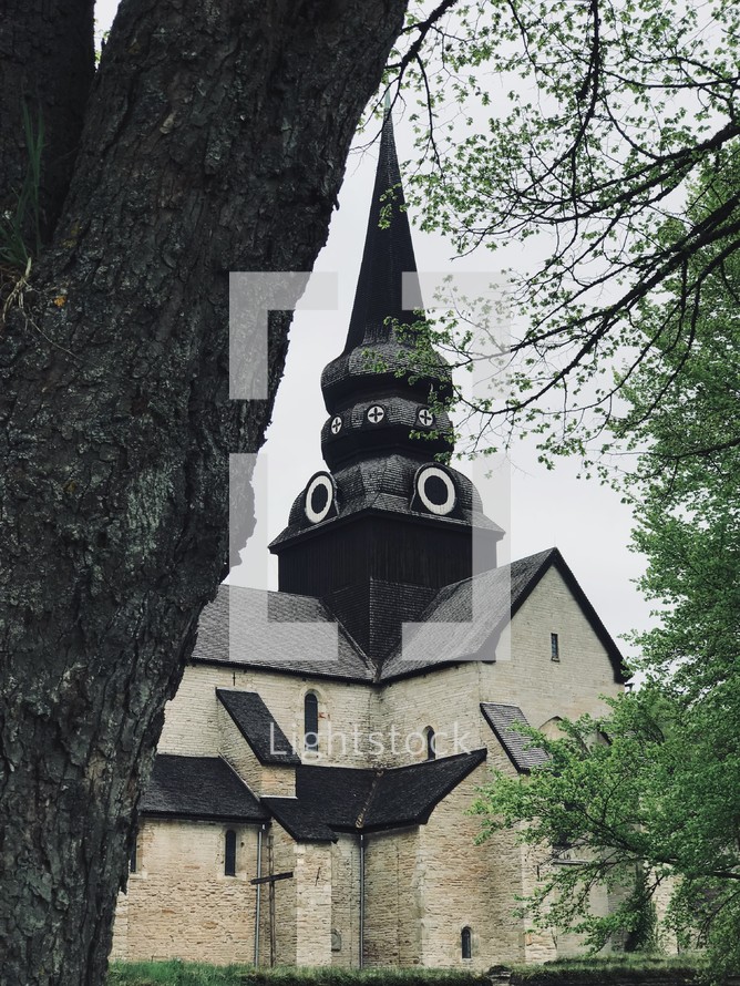 black steeple on a stone church 