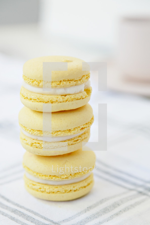 macaroons stacked on a plaid tablecloth 